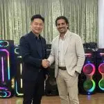 MinYi Audio business partnership handshake with client